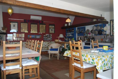 a dining room with a table and chairs at Case Zuccaro in Trecastagni