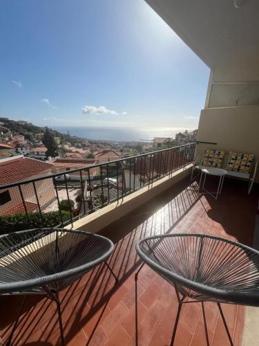 a balcony with two tables and a view of the ocean at Cantinho dos M&M in Funchal