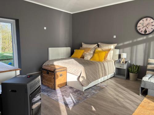 a bedroom with a bed and a clock on the wall at Authentic Travellers Suite in ehemaliger Gärtnerei in Meerbusch
