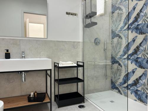 a bathroom with a sink and a shower at Lilium Suites in Rome