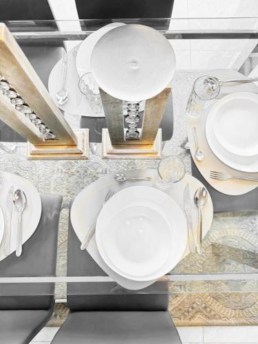 a table with white plates and silverware on it at Modern Retreat in San Miguel