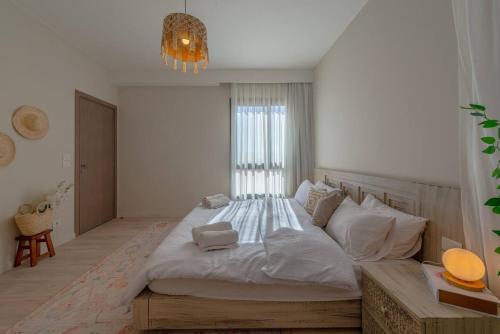a bedroom with a large bed and a chandelier at Stylish 3 BR Retreat at Ancient Hills El Gouna in El Gouna