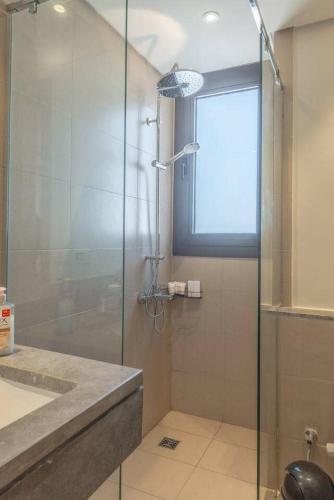 a bathroom with a shower with a glass door at Stylish 3 BR Retreat at Ancient Hills El Gouna in El Gouna