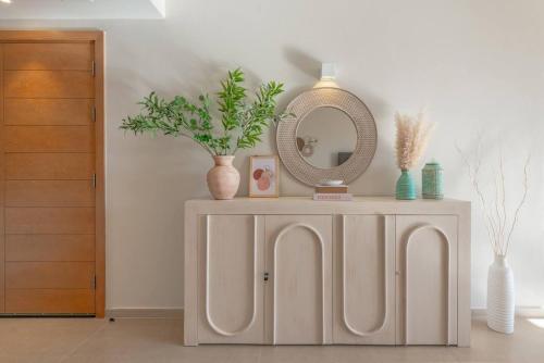 a dressing table with a mirror and plants on it at Stylish 3 BR Retreat at Ancient Hills El Gouna in El Gouna