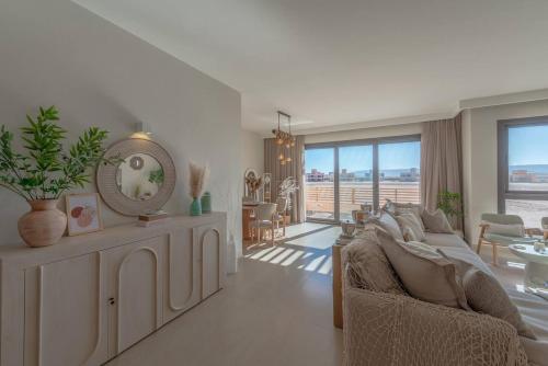 a living room with a couch and a mirror at Stylish 3 BR Retreat at Ancient Hills El Gouna in El Gouna