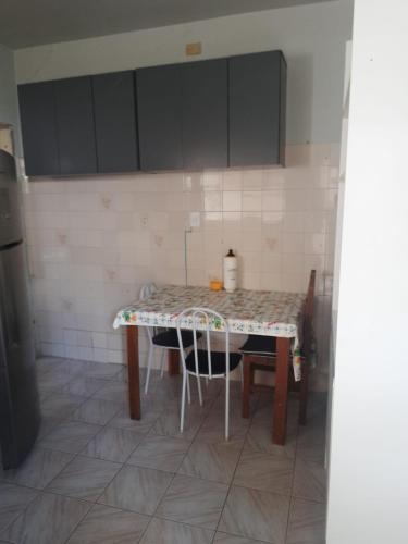 a kitchen with a table and chairs in it at Hostel Sancris 2 in São José dos Campos