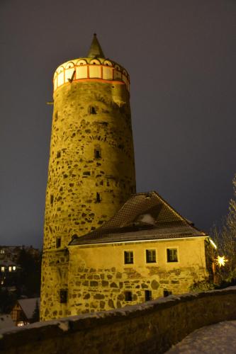 a tall stone lighthouse sitting on top of a building at Ferienappartements "Landromantik" in Bautzen