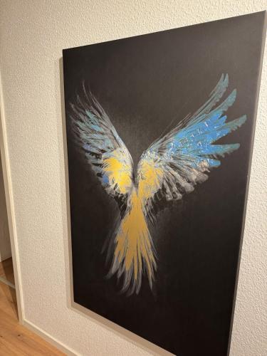 a picture of a painting of a bird with wings at Wohlfühl-Insel in der Altstadt in Zeitz