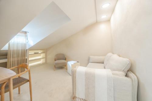 a white living room with a couch and a table at lo͝or luxury retreat in Split