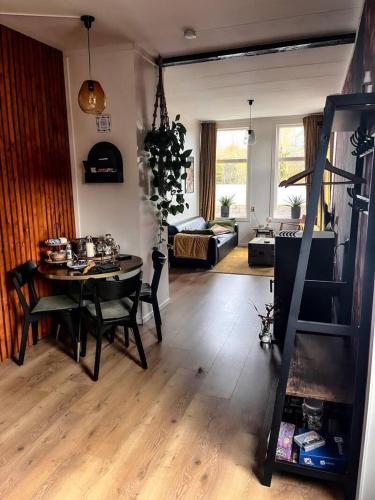 a living room with a table and a dining room at B & B Twijfelveld in Assen