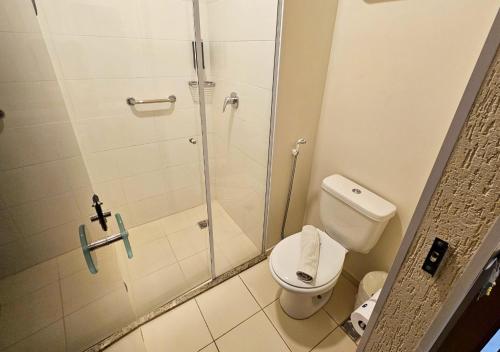 a bathroom with a shower and a toilet at Hotel Rainha dos Apóstolos in Aparecida