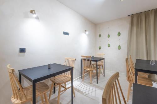 a dining room with two tables and chairs at lo͝or luxury retreat in Split