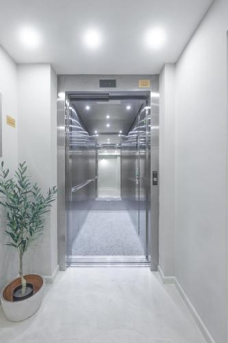 an elevator hallway with a potted plant in the middle at lo͝or luxury retreat in Split