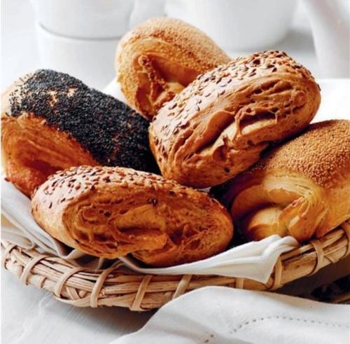 a basket filled with different types of bread at Ribe Camping in Ribe