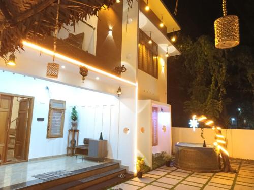 a house with a tub in the front yard at night at Pepper Jazz Varkala in Varkala
