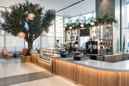 a man standing at the counter of a coffee shop at Four Seasons Hotel Minneapolis in Minneapolis