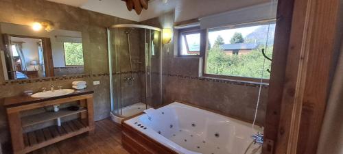 a large bathroom with a tub and a sink at Casa Nico in San Carlos de Bariloche