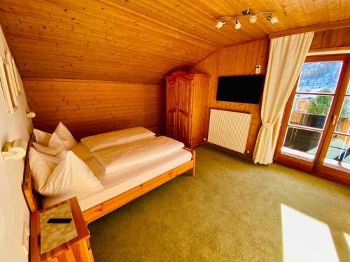 a bedroom with a bed in a wooden room at Haus Plattenkar in Obertauern