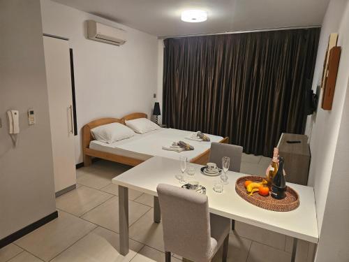 a room with a bed and a table with wine bottles at Kristal Paris Resort in Novalja