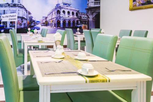 a restaurant with tables and chairs with hats on them at Add Plus Hotel & SPA in Patong Beach