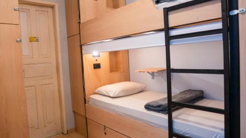 a room with a bunk bed and a ladder at Mango Tree Ipanema in Rio de Janeiro