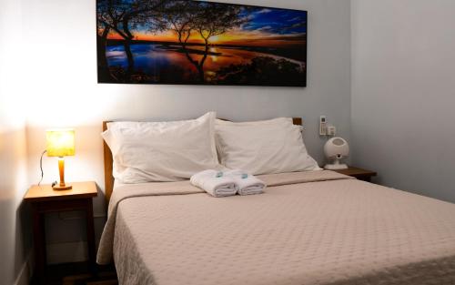 a bedroom with a bed with a towel on it at Mango Tree Ipanema in Rio de Janeiro
