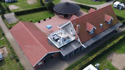 an overhead view of a house with a large roof at Ribe Camping in Ribe