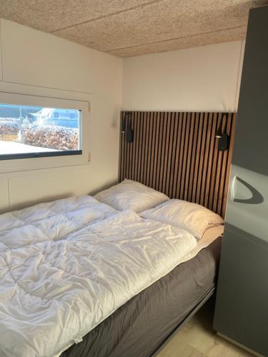 a large bed in a bedroom with a window at Ribe Camping in Ribe