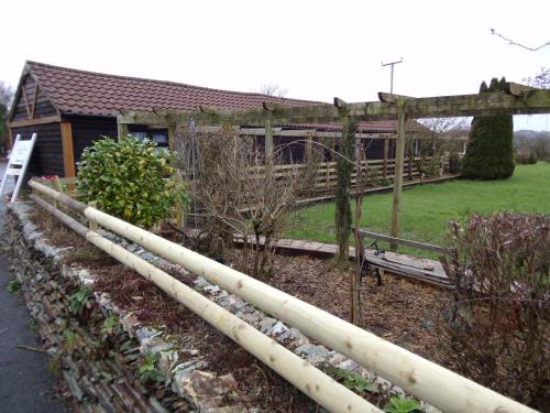 a garden with white pipes in front of a house at Barton Gate Farm B&B in Bude