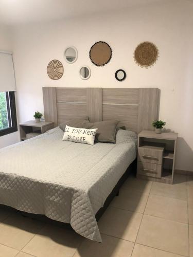 a bedroom with a bed and two mirrors on the wall at Terra Bella Hidromasajes in San Antonio de Arredondo