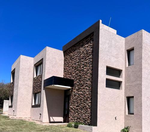 - un bâtiment avec un mur en briques et en pierre dans l'établissement Terra Bella Hidromasajes, à San Antonio de Arredondo