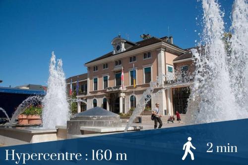 a building with two fountains in front of a fountain at Coloc Dormant - Hyper-centre, proche transports pour Genève. in Annemasse