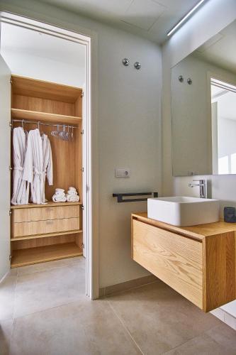 a bathroom with a sink and a mirror at Abama Lux Tenerife in Tejina de Isora