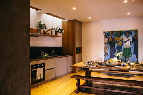 a kitchen with a wooden table in a room at Casa Santa Clara - Colonial Boutique Hotel in Quito