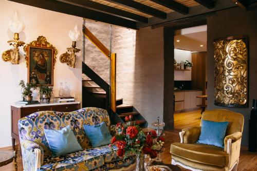a living room with a couch and a chair at Casa Santa Clara - Colonial Boutique Hotel in Quito