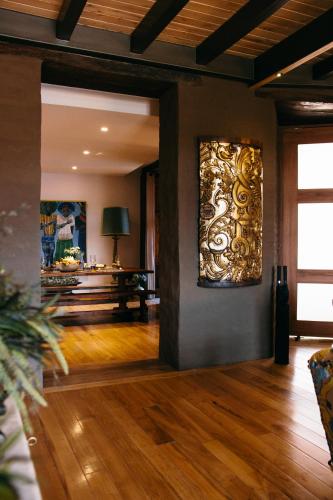 a living room with a large painting on the wall at Casa Santa Clara - Colonial Boutique Hotel in Quito