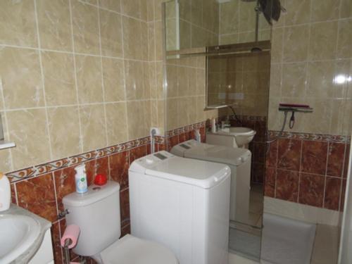 a bathroom with a toilet and a sink and a mirror at Gruissan Village APPT Duplex 51m2 in Gruissan