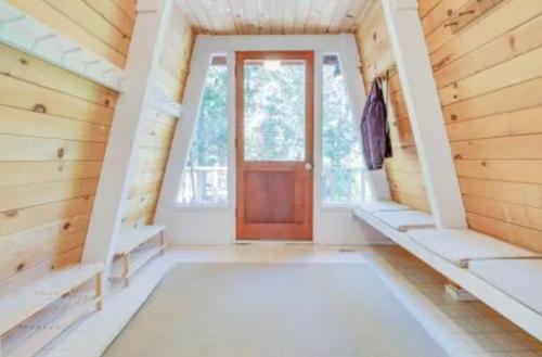 a large room with a door and a window at Modern and Private Cabin in the Woods in Carnelian Bay