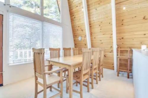 a dining room with a wooden table and chairs at Modern and Private Cabin in the Woods in Carnelian Bay