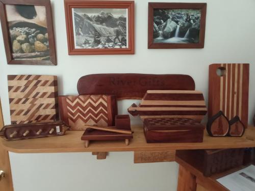 a table with various wooden items on top of it at La Frontera Bed & Breakfast, Valle Cochamó in Cochamó