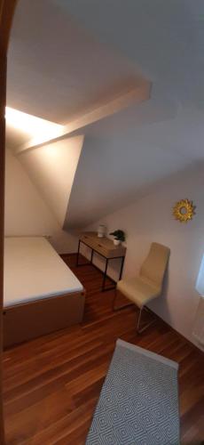 a small room with a bed and a table at Ferienwohnung zum IRRSEE 79 Mondseeland in Zell am Moos