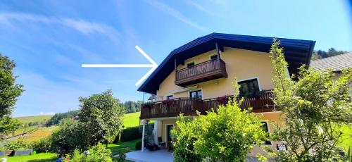 a building with a white cross on top of it at Ferienwohnung zum IRRSEE 79 Mondseeland in Zell am Moos