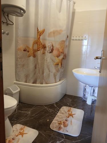 a bathroom with a shower with a toilet and a sink at Apartman Diana in Kraljevica