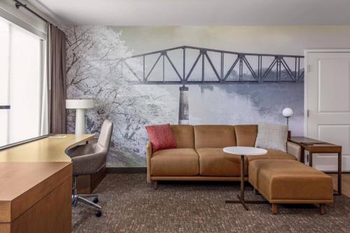 a living room with a couch and a train mural at Residence Inn by Marriott Tuscaloosa in Tuscaloosa
