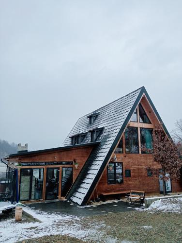 a house with a roof with a staircase on it at Cabana 3 Stejari Maramureș in Călineşti