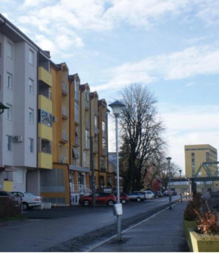a city street with buildings and a street light at Apartman River - stan na dan Gradiška in Bosanska Gradiška