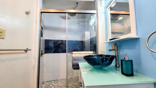 a bathroom with a sink and a glass shower at Loza house coastal design unit with lake & mountain views in Plattsburgh