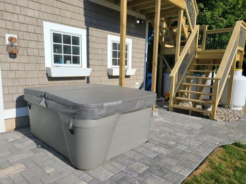 a large trash can sitting outside of a house at Loza house coastal design unit with lake & mountain views in Plattsburgh