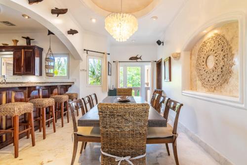 a kitchen and dining room with a table and chairs at Belizean Cove Estates Beachfront Villas in San Pedro