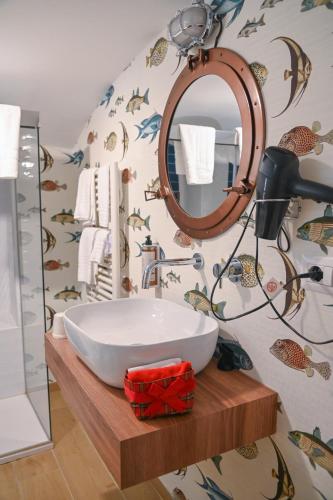 a bathroom with a white sink and a mirror at Le residenze del capitano in Bari
